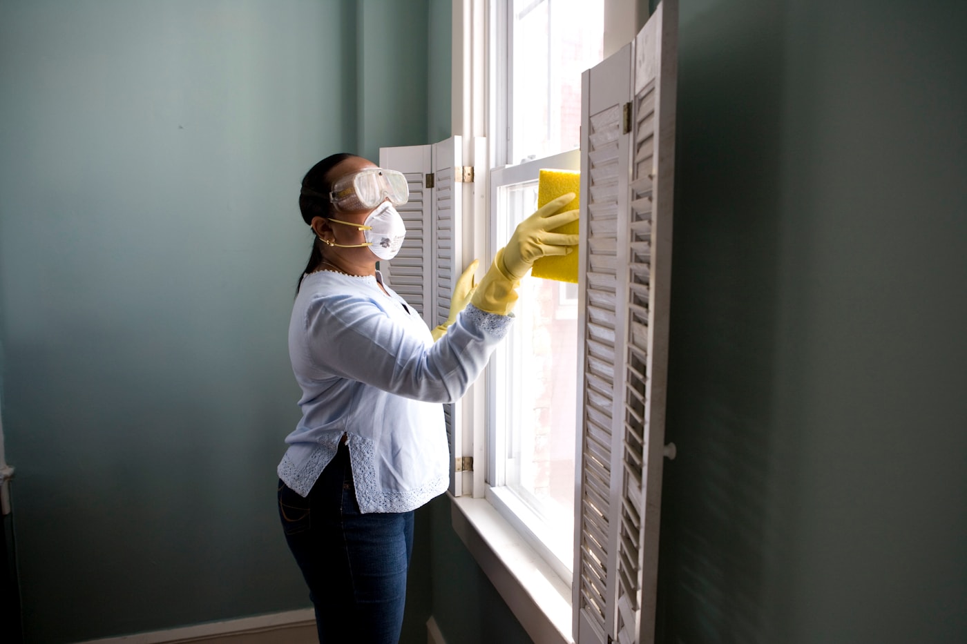 Professional cleaner wiping a bright domestic surface